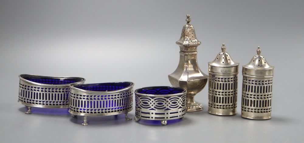 A George V four piece pierced silver condiment set, Birmingham 1916, a similar salt and an octagonal pepper